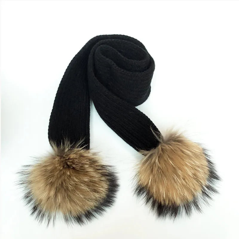 Thin scarf with fur pom moms on the ends. Available in a variety of colors.