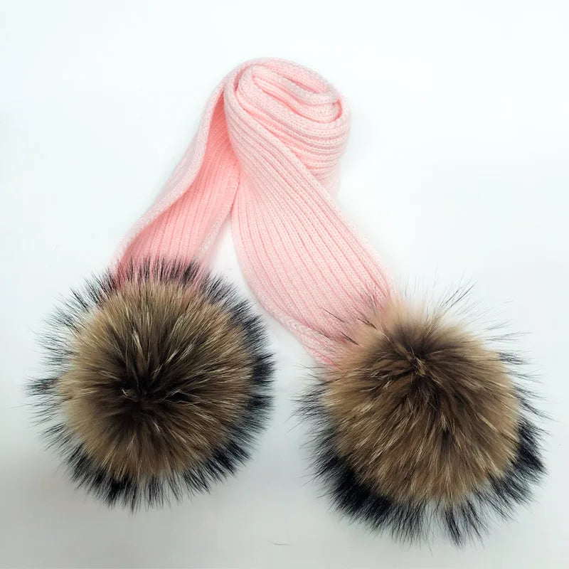 Thin scarf with fur pom moms on the ends. Available in a variety of colors.