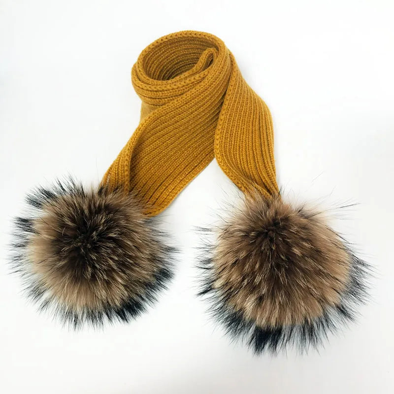 Thin scarf with fur pom moms on the ends. Available in a variety of colors.