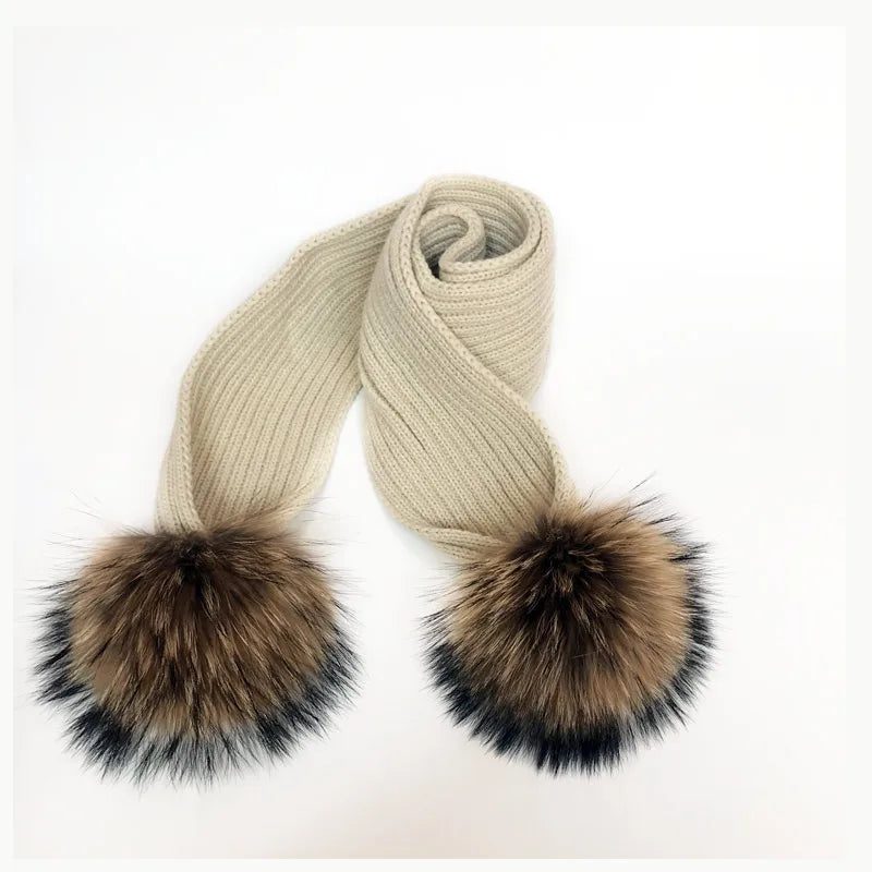 Thin scarf with fur pom moms on the ends. Available in a variety of colors.