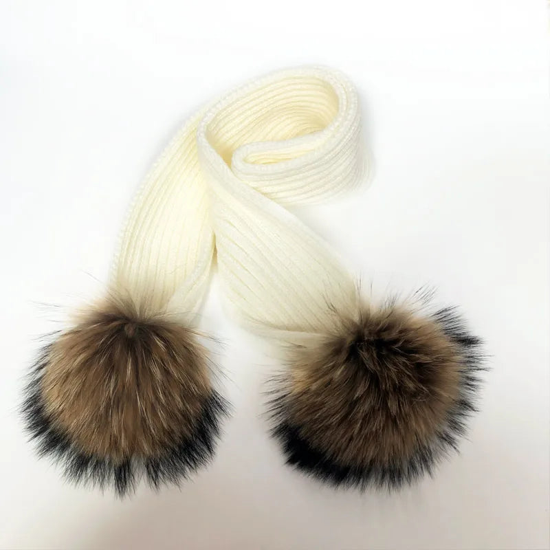 Thin scarf with fur pom moms on the ends. Available in a variety of colors.