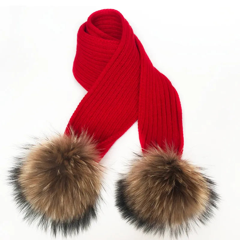 Thin scarf with fur pom moms on the ends. Available in a variety of colors.