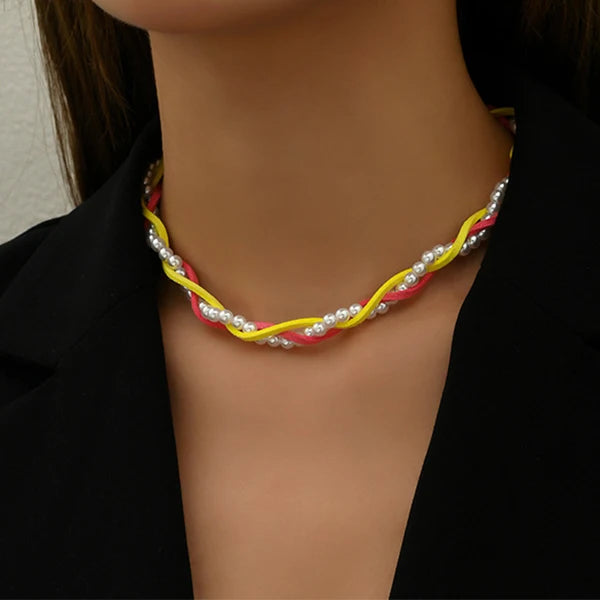 Three intertwined rope necklaces of pearl, golden and red rope style choker