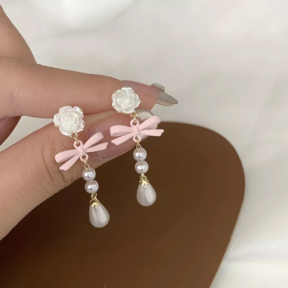 Drop earrings with pearls and pink bow