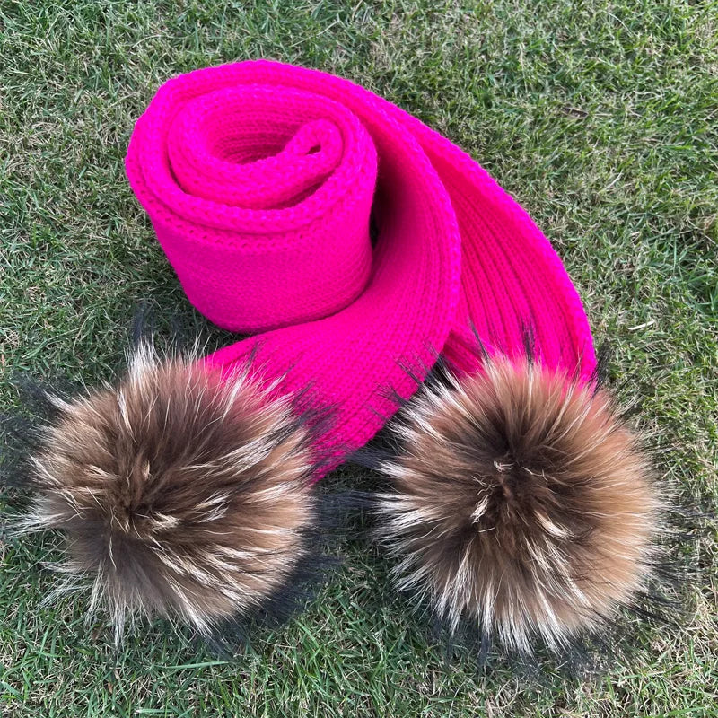 Thin scarf with fur pom moms on the ends. Available in a variety of colors.