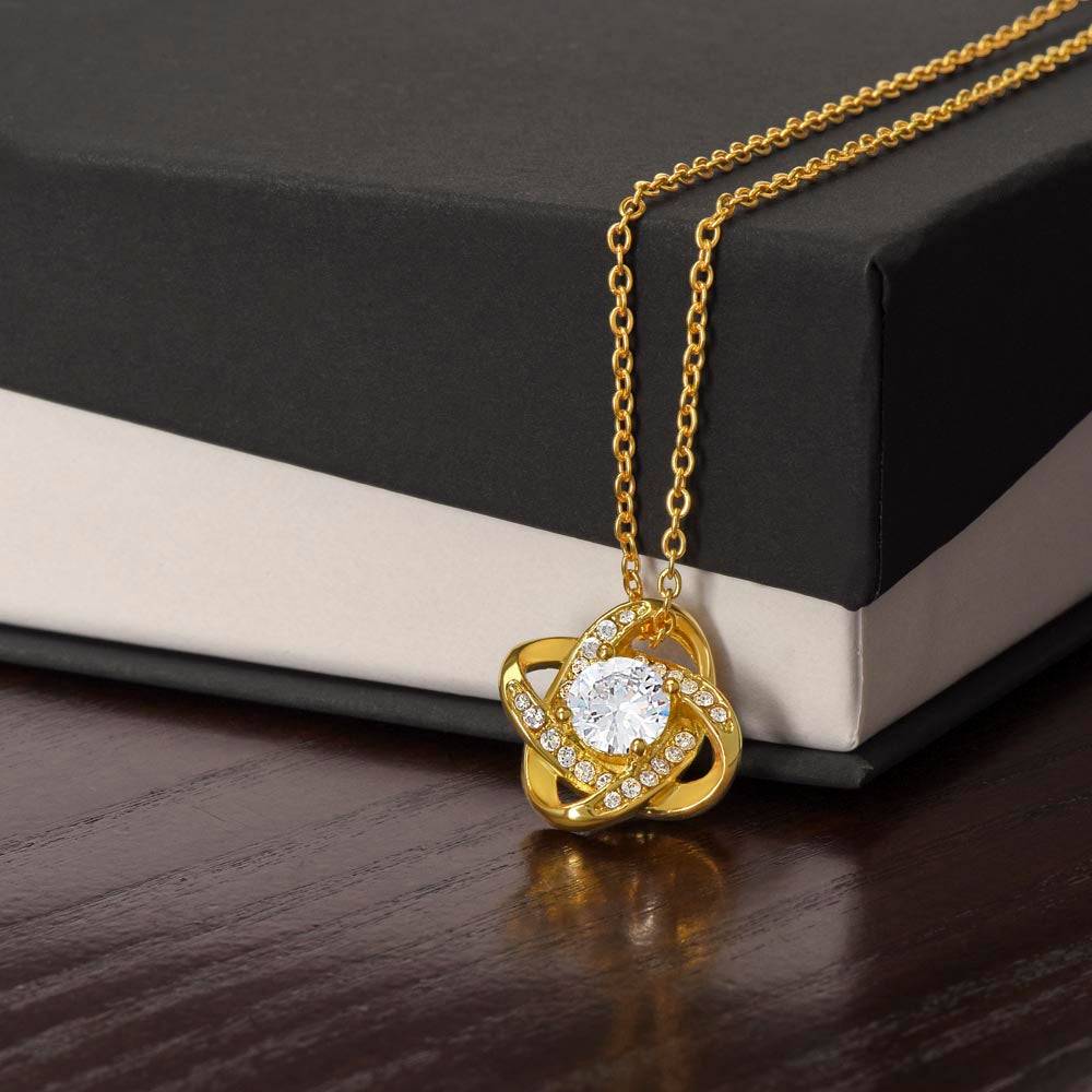 Love knot pendant necklace. Two sparkling circles intertwined with a larger crystal in the center. Hung as a pendant on a beautiful chain. In gold or silver. Comes in display box