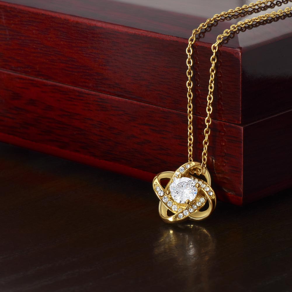 Love knot pendant necklace. Two sparkling circles intertwined with a larger crystal in the center. Hung as a pendant on a beautiful chain. In gold or silver. Comes in display box